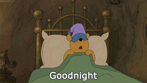 Pooh hugs his pillow before sleeping