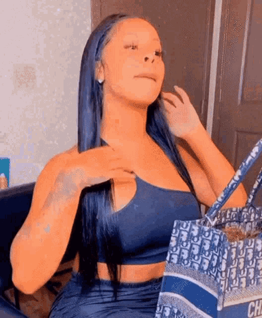 This baddie in a blue outfit flips her hair