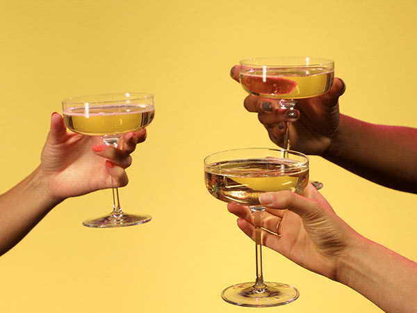 These friends clink their glasses to celebrate