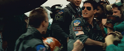 A happy Tom Cruise celebrating with his pilot friends