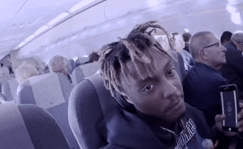 Juice Wrld taking a selfie video on an aeroplane