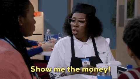 A curly woman says "Show me the money" to someone