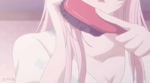 An anime girl brushing her pink hair