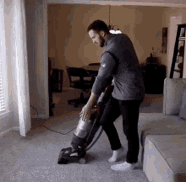 This man is dancing while cleaning the carpet